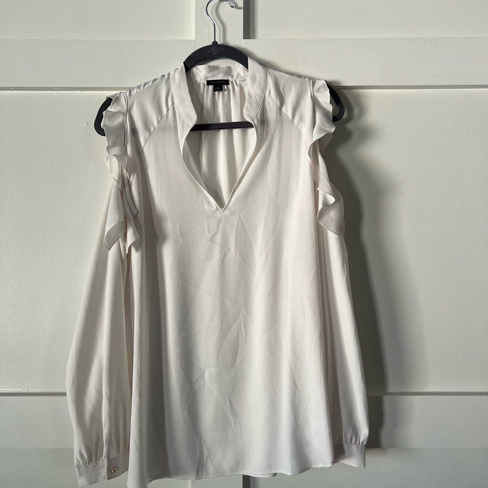 Ivory blouse with shoulder cut out.